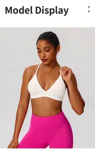 Detail of white cross-back sports bra and pink high-waist yoga leggings on model