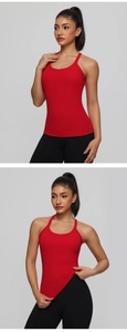 Detailed view of red ribbed yoga tank top with racerback design and elastic fabric texture