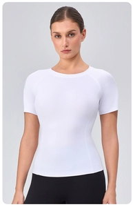 Close-up of white high-elastic yoga t-shirt showing refined texture and ergonomic seams