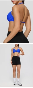 Detail view of navy halter sports bra with gathering and black high waist gym shorts