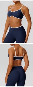 Deep blue yoga set with white contrast trim featuring ruched sports bra and high waist leggings