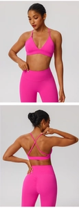 Detailed back view of deep pink sports bra with cross straps and ruched yoga leggings