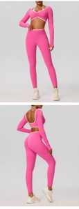 Detail view of pink long sleeve yoga top with white contrast trim and open back design