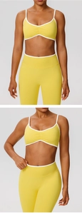 Detail of yellow sports bra with white trim contrast and ruched center design
