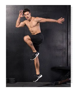 Close-up of men's compression sports shorts in gym setting with high-elasticity fabric