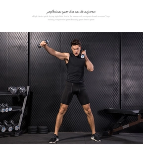 Detail showing white stitching on men's black compression shorts and sleeveless shirt