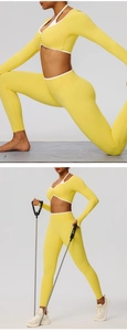Detail view of bright yellow high-stretch yoga set with contrasting white trim and V-neck