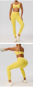 Detail of high-stretch yellow yoga set with white piping and seamless shaping pants