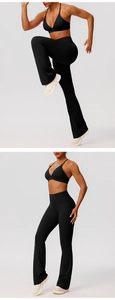 Detail view of high-waisted black yoga set with flared pants and sports bra in motion