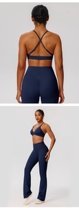 Detail of cross-back sports bra and high-waisted scrunch butt yoga pants in navy blue
