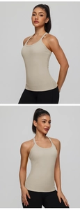 Detailed close-up of beige ribbed yoga tank top with racerback and built-in bra pads