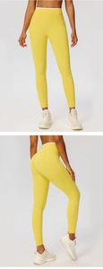 Detail showing high-waist yellow yoga pants with butt-lifting pleats and white contrast trim