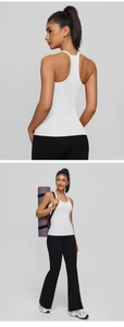 Detail of white racerback yoga tank top and black high-waisted flare fitness leggings