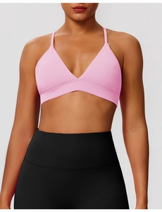 Pink strapless sports bra and high waisted black yoga leggings on fitness model