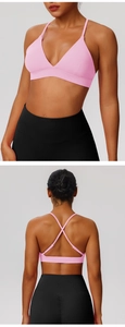 Detail view of pink cross-back sports bra and black high-waisted yoga leggings