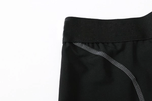Flatlock stitching detail on black high-elastic waistband for men's compression shorts