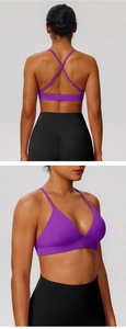 Close-up of purple criss-cross sports bra and black leggings with high-waist yoga fit