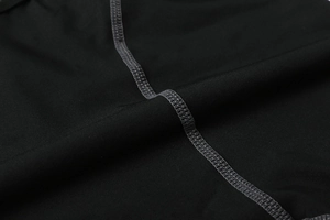Close-up of durable gray flatlock stitching on black high-elastic men's compression shorts