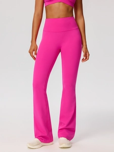 Women's pink flare yoga set featuring high-waist flared leggings and cropped sports top