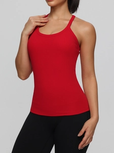Women's red breathable yoga tank top with built-in pads and a slim fit racerback design