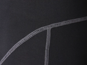 Detail of grey flatlock stitching on elastic black compression sports fabric