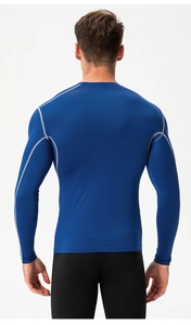 Detail of blue compression sports shirt showing gray contrast stitching and elastic fabric