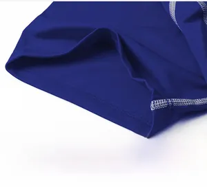 Detail of white reinforced stitching on blue elastic athletic fabric for men's compression shirt