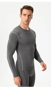 Detail of grey men's compression suit featuring contrast stitching and athletic fit