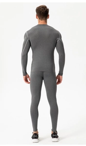 Rear view of men's compression suit with ergonomic flatlock seams in charcoal grey