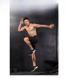 Action shot of men's Pro compression sports shorts in black high-stretch performance fabric