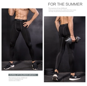 Detail view of men's black compression pants featuring an elasticated Y-E-L PRO waistband