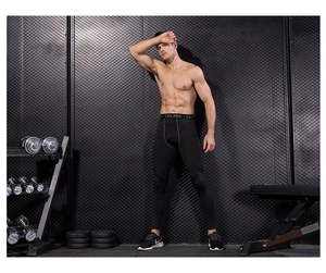 Detail of men's compression pants featuring wide elastic waistband and ergonomic seams