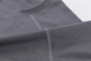 Detail of flatlock stitching on the grey crew neck athletic shirt with reinforced collar