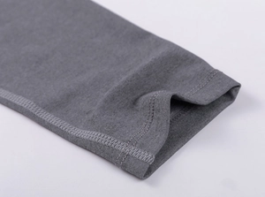 Close-up of double-stitched cuffs on dark gray moisture-wicking compression shirt
