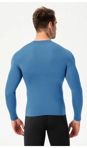 Macro detail of elastic moisture-wicking fabric on men's athletic blue compression shirt