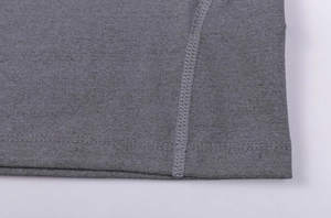 Macro shot of double-needle hem stitching and charcoal gray elastic fabric on men's sport tee