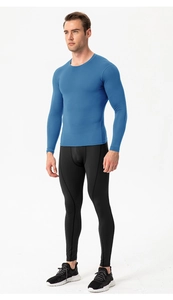 Men's compression suit featuring royal blue long sleeve top and black leggings for training