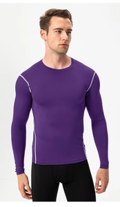 Detail view of purple compression shirt featuring grey flatlock stitching and round collar