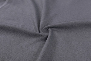 Macro view of dark grey moisture-wicking fabric showing soft texture and high elasticity