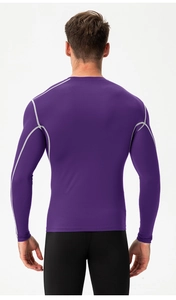 Detail of ergonomic flatlock seams on men's purple compression long sleeve fitness top