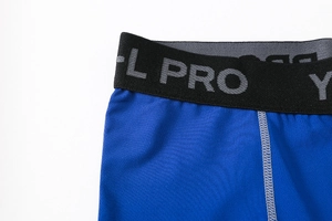 Detail of blue men's compression shorts showing elastic waistband and knit fabric texture