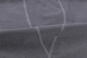 Close-up of high-elastic dark grey gym shirt featuring professional flatlock stitching