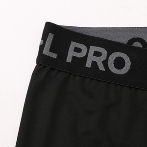 Detail of wide elastic waistband with grey L PRO text on black compression pants