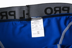Detail of waist label showing 85% polyester and 15% spandex blend for sports shorts