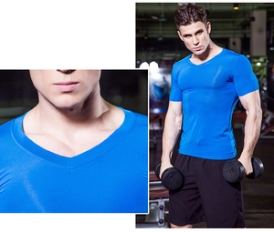 Close-up of V-neck stitching and muscle fit on men's blue compression sports t-shirt