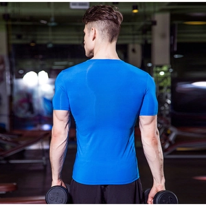 Close-up of bright blue compression sports shirt showing moisture-wicking fabric texture