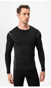 Detail of men's black compression long sleeve shirt with gray reinforced muscle stitching