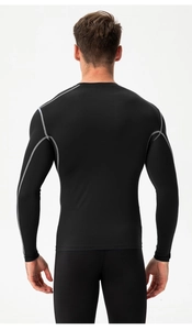 Rear view of black compression shirt showing contrast gray stitching and ergonomic seams