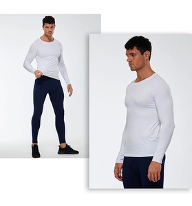 Detail view of men's white compression shirt and navy blue sports leggings fit