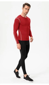Men's athletic compression suit with red long sleeve top and black leggings for gym workout